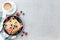 Waffles plate on table with blueberry, strawberry, mint and white cup of coffee