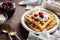 Waffles with sour cream and cherry jam