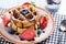 Waffles with strawberry ,blueberry poured with chocolate