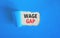 Wage gap symbol. Concept words Wage gap on beautiful white paper on a beautiful blue background. Business, support and wage gap