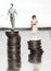 Wage inequality concept  with male and female figurines on coins