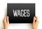 Wages - payment made by an employer to an employee for work done in a specific period of time, text concept on card