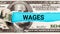 Wages word written on with American Dollar-bills. Salary and wages concept. The word wages on dollar usa background