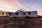 Wagin, Australia - Mar 12,2021: A large white caravan and modern 4WD vehicle free camp next to the nearly dry salt Lake Norring