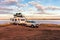 Wagin, Australia - Mar 12,2021: A large white caravan and modern 4WD vehicle free camp next to the nearly dry salt Lake Norring