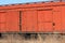 Wagon of an old rusty freight train stands on the rails