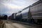 Wagons on railroad track fuel transportation rail cargo tank cloudy sky