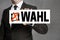 Wahl in german Election sign is held by businessman