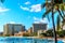 Waikiki Beach, with its many resorts under blue sky and white sand