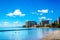 Waikiki Beach, with its many resorts under blue sky and white sand,