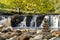 Wain Wath waterfall, with stacked stones in the foreground. Bokeh