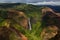 Waipoo Falls in Waimea Canyon in vivid greens and reds on the is