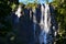 Wairere Waterfall detail, huge amouth of water falling into deep forest,