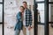 Waist up of cheerful couple standing at the entrance of their kitchen