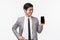 Waist-up portrait of proud professional young asian male office worker, entrepreneur introduce his mobile phone