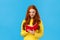 Waist-up portrait redhead female student write down thoughts in red lovely notebook, prepare grocery list, make schedule