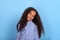 Waist up  portrait of smiling mulatta frizzy girl  on a blue background with copy space