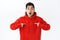 Waist-up portrait of surprised, amazed asian man in red hoodie, shocked he was picked from all candidates, pointing at