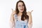 Waist-up shot of enthusiastic charming european female brunette in glasses and overalls showing thumbs up in like and