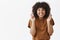 Waist-up shot of good-looking faithful and optimistic teenage african american girl with afro hairstyle crossing fingers