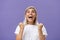 Waist-up shot of grateful delighted lucky girl with attractive tan in white t-shirt clenching fist from positive