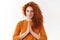 Waist-up shot peaceful calm and relieved cute redhead woman, close eyes smiling hold hands in pray, talking god