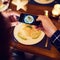 Wait a quick photo before we dig in. Shot of an unrecognizable man taking a picture of food with his cellphone at the