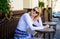 Wait for waitress. Woman sits alone bored cafe terrace urban background defocused. Girl sit alone cafe waiting waitress