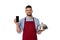 Waiter in apron holding smartphone and tray with cloche isolated on white