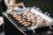 Waiter bring portioned salmon and beef tartare on a tray. Close-up of snacks in sunset on terrace