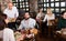 Waiter bringing order to visitors in rural restaurant