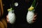 Waiter carries two white cocktails