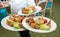 Waiter carrying plates with appetizers