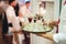 Waiter carrying tray with several various alcoholic drinks. Man serving beverages. Celebration, birthday, party, wedding