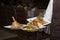 Waiter carrying tree plates with meat dish on some festive event