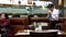 Waiter cleaning table and putting sugar bags in order