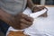 Waiter folds napkins in restaurant. Waiters hands with white napkin closeup