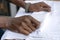 Waiter folds napkins in restaurant. Waiters hands with white napkin closeup