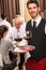 Waiter hold wine glasses business lunch restaurant