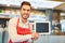 Waiter holding blank chalkboard in bar or restaurant