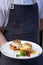 Waiter holding breakfast tray with Eggs Benedict