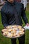 A waiter holding a platter full of wooden bowls with appetizers - wedding catering series