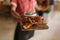 Waiter holding a serving board of freshly baked nachos