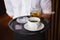 Waiter holding tray with coffee cup and pint of beer