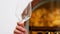 Waiter looking at glass of wine at counter