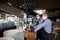 Waiter in a medical protective mask serves  the coffee in restaurant