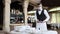 A waiter in a medical protective mask serves the table in the restaurant