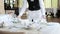 A waiter in a medical protective mask serves the table in the restaurant