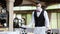 A waiter in a medical protective mask serves the table in the restaurant