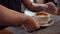 Waiter places a white cup of coffee on a napkin in front of the customer.